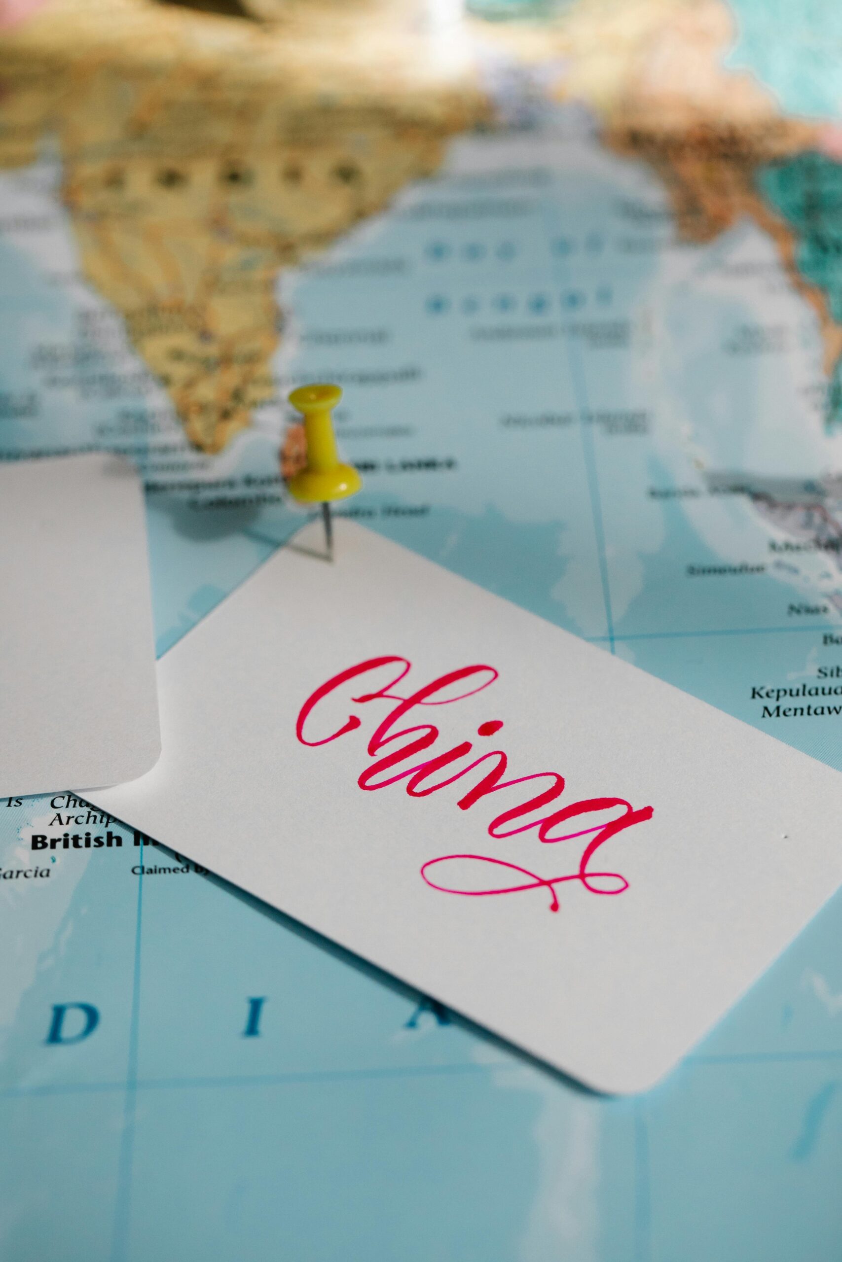 Close-up of a map of Asia with a card labeled 'China' and a pin.